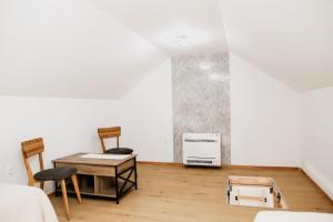 a room with a table and chairs and a refrigerator at Aurora in Ljubuški +2 photos