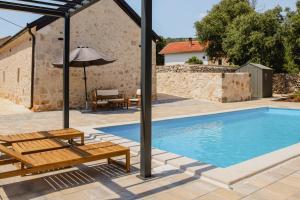 a villa with a swimming pool and a house at Aurora in Ljubuški