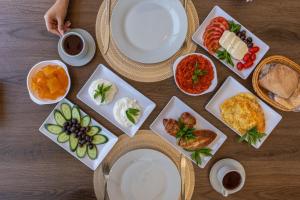 a table with plates and bowls of food on it at Saint Paul Guesthouse in Zahlé