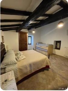 a bedroom with two beds and a tv in it at Il Carpino - Dimora Fresca e parcheggio in Carpineto Romano