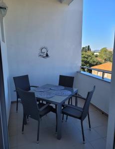 a blue table and chairs on a balcony at Mary in Zadar +11 photos