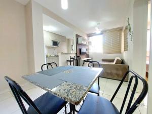 a dining room table and chairs in a room at Graciosa Reserva Ipanema in Porto Alegre