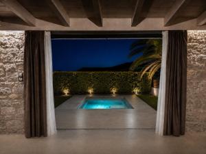 a swimming pool in a backyard at night at ARMONIA 1 & 2 in Myrina