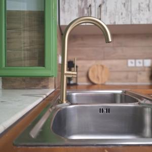 a stainless steel kitchen sink with a faucet at Alekos Cozy Stone 2BR Home Karya Center in Lefkada +25 photos