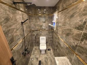 a bathroom with a toilet in a stone wall at Sol Pyramids Rooftop View Giza in Cairo +48 photos