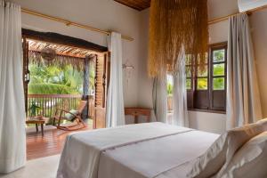a bedroom with a bed and a large window at Reserva Pratigi in Ituberá +115 photos
