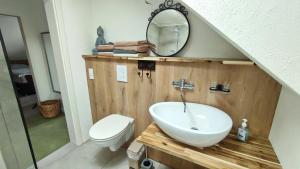 a bathroom with a sink and a toilet and a mirror at Bergblick2 in Zell an der Mosel +13 photos