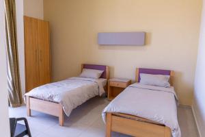 a room with two beds in a room at Saint Paul Guesthouse in Zahlé +5 photos