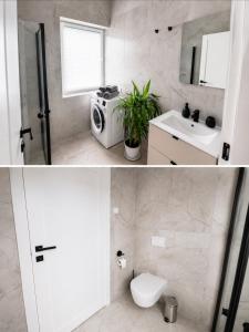 a white bathroom with a toilet and a sink at Wake&wave in Užpelkiai +4 photos