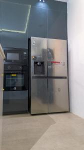 a kitchen with a refrigerator and a stove at Reign Residence in Port Harcourt