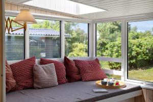 a couch with pillows sitting in front of a window at OH593-Hadsund-Halvrebene-124 in Hadsund