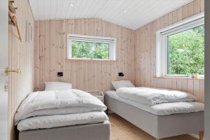 a bedroom with two beds and a window at OH593-Hadsund-Halvrebene-124 in Hadsund