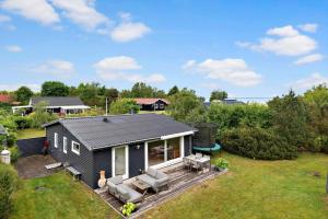 a tiny house with a porch and a deck at OH593-Hadsund-Halvrebene-124 in Hadsund