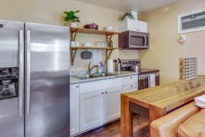 a kitchen with a stainless steel refrigerator and a wooden table at The Nook in Coeur d'Alene