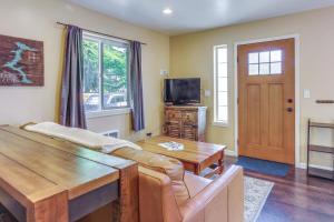 a living room with a couch and a table and a tv at The Nook in Coeur d'Alene
