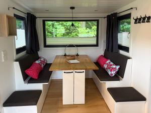 a tiny house with a table in the middle at Tiny House Hameln in Salzhemmendorf