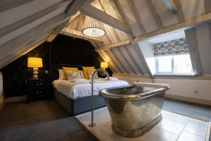 a bathroom with a tub in a room with a bed at Best Western Red Lion Hotel in Salisbury