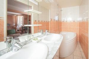 a bathroom with two sinks and a mirror at Logis Hôtel Auberge Lukaïna in Urrugne +29 photos