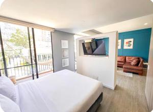 a bedroom with a bed and a flat screen tv at Distrito Prime 1-302 in Bogotá +18 photos