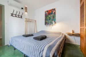 a bedroom with a bed with two pillows on it at Casa Terraza in La Herradura