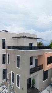 a building with a balcony on top of it at Reign Residence in Port Harcourt