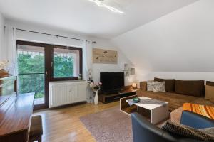 a living room with a couch and a tv at Fewo Krick in Bad Soden-Salmünster