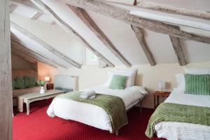 a bedroom with two beds and a couch at Logis Hôtel Auberge Lukaïna in Urrugne