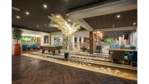 a restaurant with a table and a tree in the middle at Holiday Inn Newcastle-Jesmond by IHG in Newcastle upon Tyne