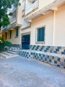 a house with blue and white tiles on the front of it at Studio Kilifi -Pendoraha Homes in Kilifi