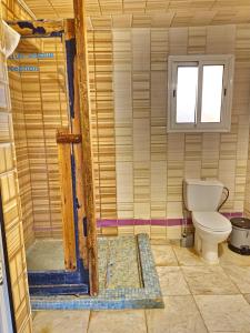 a bathroom with a toilet and a window at Villa Galactik Pegasus in Tamraght Ou Fella +24 photos