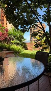 a table and a chair sitting on a patio at Cabecera House in Bucaramanga