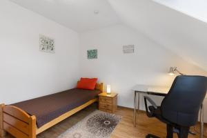 a bedroom with a desk and a bed and a chair at Fewo Krick in Bad Soden-Salmünster