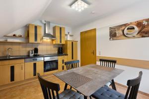 a kitchen with a table and chairs in a room at Fewo Krick in Bad Soden-Salmünster
