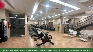 a gym with treadmills and exercise bikes in a room at Veleiros Mar Hotel in São Luís