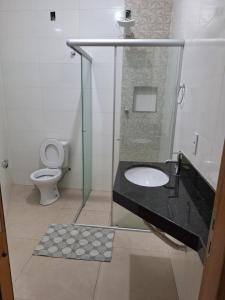 a bathroom with a sink and a toilet at Apartamento Aconchegante 3 in Doutor Lund +9 photos