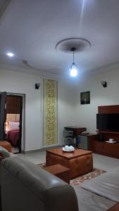 a living room with a couch and a coffee table at Hotel 101 & Apartments in Karsana