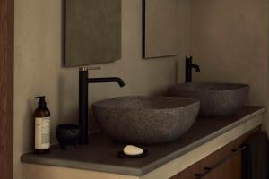 two sinks sitting on a counter in a bathroom at Zelia Halkidiki, part of Destination by Hyatt - Adults Only in Nea Potidaea