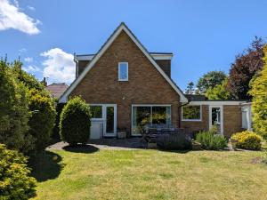 a brick house with a patio and yard at Still Waters, Emsworth in Emsworth
