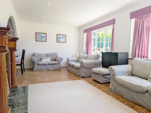 a living room with two couches and a flat screen tv at Still Waters, Emsworth in Emsworth