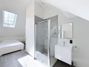 a white bathroom with a shower and a sink at Stellaross - Koksijde in Koksijde