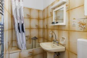 a bathroom with a sink and a mirror at Adonis Rooms in Skopelos Town +108 photos