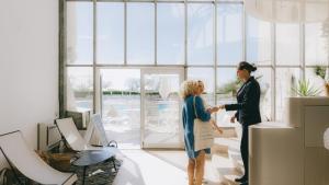 a man and woman shaking hands in a room at Hôtel Les Corallines - Thalasso & Resort in La Grande Motte +67 photos