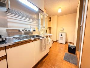 a kitchen with a sink and a counter top at ura 東横のヨコ405 in Okayama