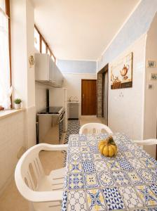 a dining room table with a blue and white table cloth at Dream Beach Salento in Porto Cesareo +18 photos