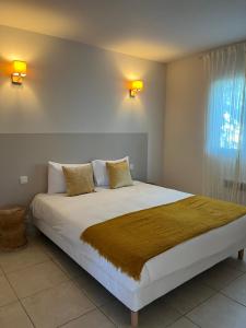 a bedroom with a large white bed with two pillows at CASA Petra Rosa in Peri