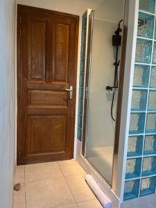 a bathroom with a shower and a wooden door at CASA Petra Rosa in Peri +5 photos