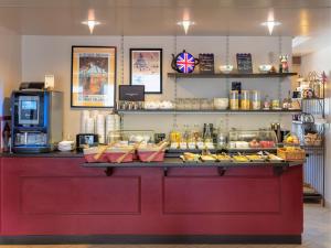 a red counter with food on top of it at Hôtel La Résidence in Roscoff