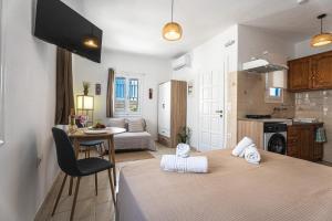 a living room with two beds and a kitchen at Tzivaeriparos studio in Piso Livadi