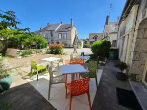 a group of tables and chairs on a patio at La Part'Thé in Crouy-sur-Cosson