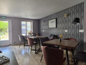 a dining room with tables and chairs and a window at La Part'Thé in Crouy-sur-Cosson